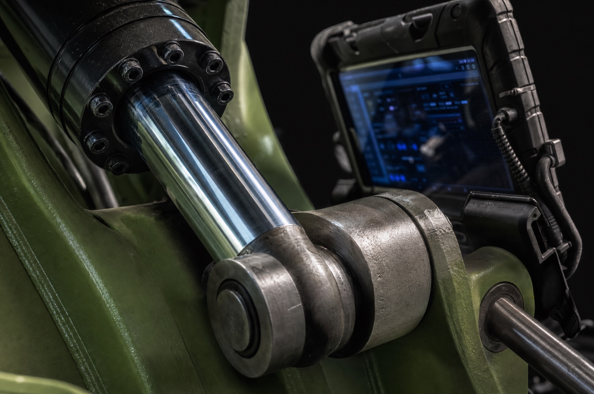 Macro detail of hydraulic cylinders and machined steel hardware